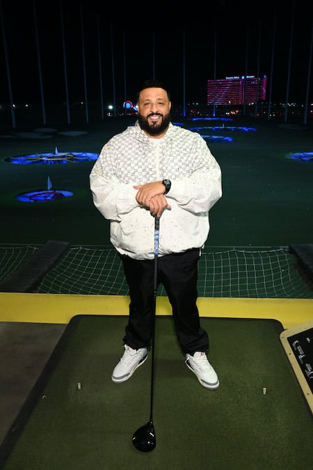 J Balvin gives DJ Khaled the sneakers off his feet on the golf